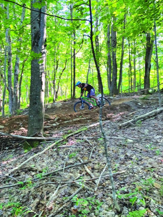 Tony Sudol bikes through the forest